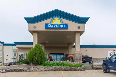 a day inn sign on the front of a building at Days Inn by Wyndham Drayton Valley in Drayton Valley
