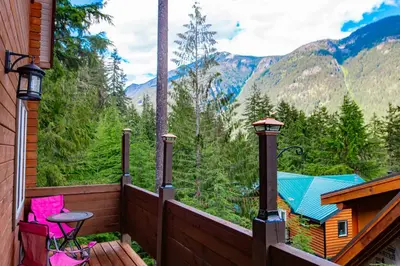 a balcony with a view of the mountains at Whiskey Jack, 4 Bedroom Cabin with Outdoor Firepit in Sunshine Valley