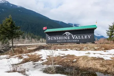 a sign for a swiss skiing valley in the snow at Whiskey Jack, 4 Bedroom Cabin with Outdoor Firepit in Sunshine Valley
