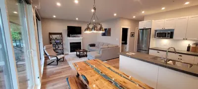 a kitchen and living room with a couch and a table at Halibut Hideaway in Port Renfrew