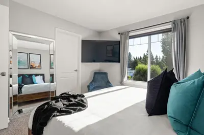 a bedroom with a bed and a large window at The Saturday I Perfect for Families I Arcade Games in Sylvan Lake