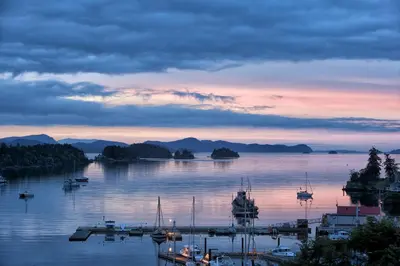 a marina with boats in the water at sunset at Mariner's Loft - Salt Spring Island in Ganges