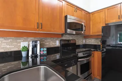 a kitchen with a sink and a microwave at Alpenglow Lodge Large Studio by MVA in Whistler