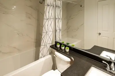 a bathroom with a toilet and a sink and a tub at Alpenglow Lodge Large Studio by MVA in Whistler