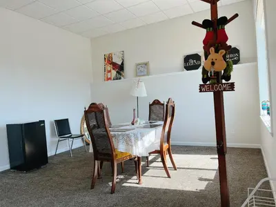 a dining room with a table and a sign that reads welcome at Peaceful and Spacious Lake View in West Kelowna
