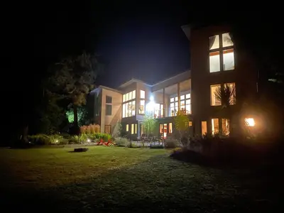 a building at night with the lights on at Liahona Guest House in Ucluelet