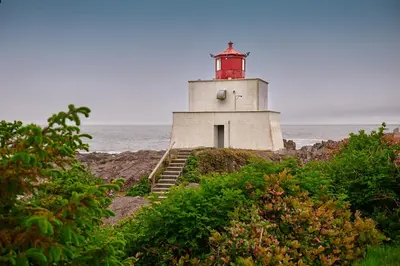 a lighthouse sitting on the edge of the ocean at Liahona Guest House in Ucluelet