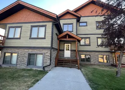 a large house with a brown roof at Copperhorn by StayIn in Radium Hot Springs