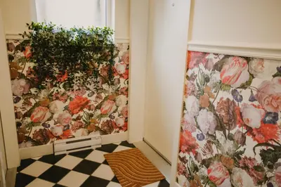a room with flowers on the wall at The Garden Room at Waddington Flats in Victoria
