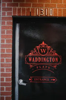 a door with a sign that reads waldorf alteration flats entrance at The Garden Room at Waddington Flats in Victoria