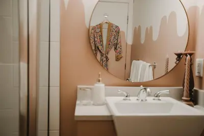 a bathroom with a sink and a mirror at The Garden Room at Waddington Flats in Victoria