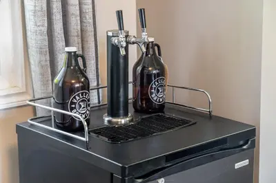 two bottles sitting on top of a black cabinet at Bahama Breeze I Hot Tub I Pool I 5 Bedroom in Drumheller