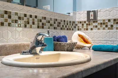 a bathroom sink with a faucet on a counter at Bahama Breeze I Hot Tub I Pool I 5 Bedroom in Drumheller