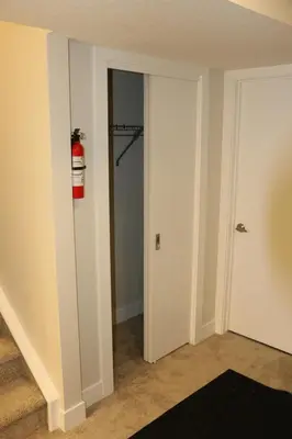 a room with a fire extinguisher on the wall at Guest Suite in Calgary in Calgary