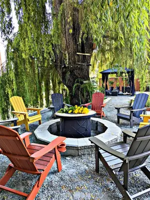 a group of chairs sitting around a fire pit at Waterfront Oasis with Pool, Hot Tub & Pet Friendly in Kelowna