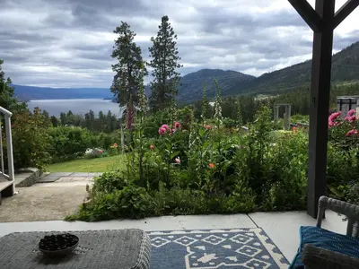 a garden with flowers and a view of a lake at Lakeview Gardens B&B in Peachland