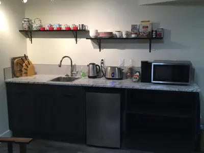 a kitchen counter with a microwave and a sink at Lakeview Gardens B&B in Peachland