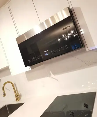 a microwave above a kitchen counter with a sink at JESI'S NEW HOUSE, Self Enter 2BR, Whole Suite, Close to White Rock Beach & US Border in Surrey