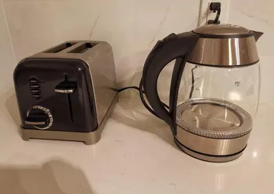 a black and silver toaster sitting on a counter at JESI'S NEW HOUSE, Self Enter 2BR, Whole Suite, Close to White Rock Beach & US Border in Surrey