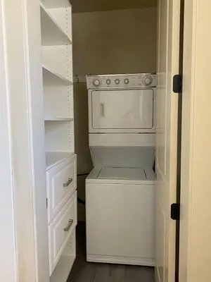 a small kitchen with a white oven and shelves at Private cozy suite near Dyke and Fisherman's Wharf in Richmond