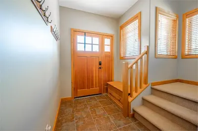 aoyer with stairs and a door and windows at Bear's Paw Chalet - Amazing Location & Ski In-Out in Big White