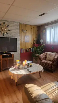 a living room with a couch and a coffee table at Charming - 2 bedrooms suite, 1 full bath & family room in Kamloops