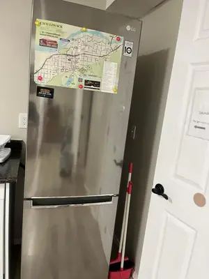 a refrigerator with a map on top of it at Licensed spacious basement suite with one king-size bed in Chilliwack