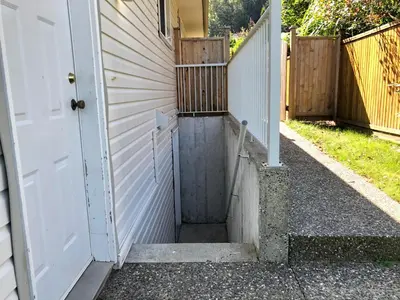 an entrance to a house with a white door at Licensed spacious basement suite with one king-size bed in Chilliwack