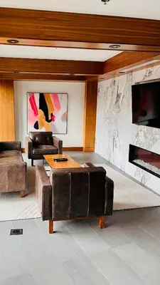 a living room with two couches and a stone wall at LUXURY DT, 2 Bedroom DEAL, Private Balcony, Full Kitchen, Gym - FREE PARKING in Calgary