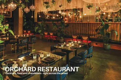a restaurant with tables and chairs and chandeliers at LUXURY DT, 2 Bedroom DEAL, Private Balcony, Full Kitchen, Gym - FREE PARKING in Calgary