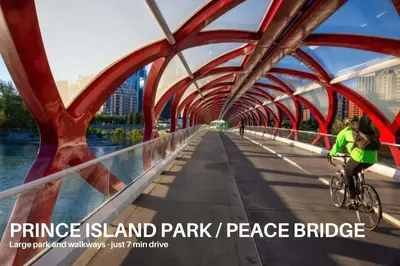 a person riding a bike on a bridge at LUXURY DT, 2 Bedroom DEAL, Private Balcony, Full Kitchen, Gym - FREE PARKING in Calgary