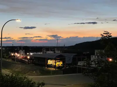 a view of a train station at sunset at Top Floor Riverfront Condo with Stellar Sunsets! in Fort McMurray