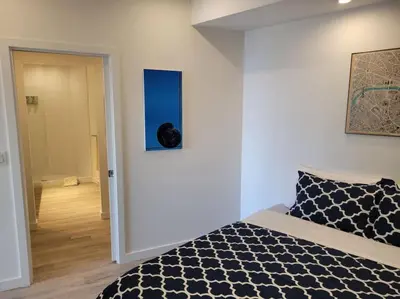 a bedroom with a black and white bed in a room at J and Js in Bowen Island