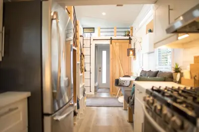 a kitchen and a living room with a stove at Tiny House Big View in Chilliwack