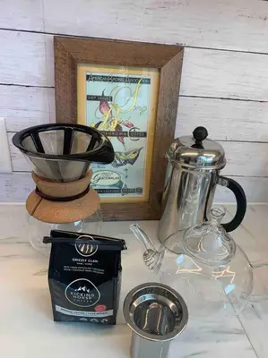 a table with a coffee maker and a tea kettle at Tiny House Big View in Chilliwack