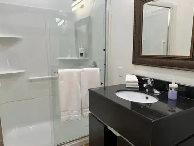 a bathroom with a sink and a glass shower at Country home, Sleeps 6 pets friendly in Port Alberni