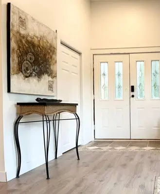 a room with a table and a painting and a door at Country home, Sleeps 6 pets friendly in Port Alberni