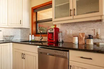 a kitchen with a red appliance on a counter at The Overlook, Luxury Lakeside Home with Dock in Harrison Hot Springs