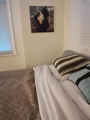 a bed in a bedroom with a picture on the wall at Vancouver sea view Palace inn in West Vancouver