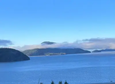 a large body of water with mountains in the background at Vancouver sea view Palace inn in West Vancouver