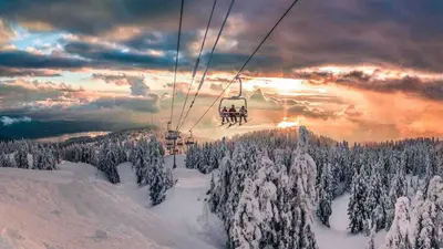 a group of people riding a ski lift in the snow at Charming, Cheerful, Exquisite 4 BR house, free wifi, free parking, free cancelation in Langley