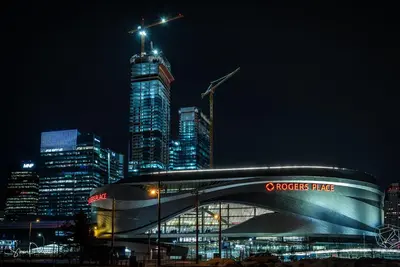 a view of a city at night with a building at Stunning Modern Suite - King Bed - Free Parking & Netflix - Fast Wi-Fi - Long Stays Welcome in Edmonton