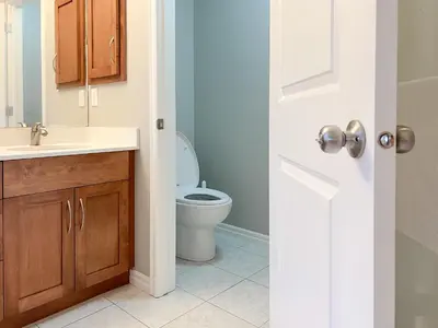 a bathroom with a toilet and a sink at Serene and Secure Home Sweet Home with Office, 15 mins to Airport, 20 mins to Downtown, 90 mins to Banff in Calgary
