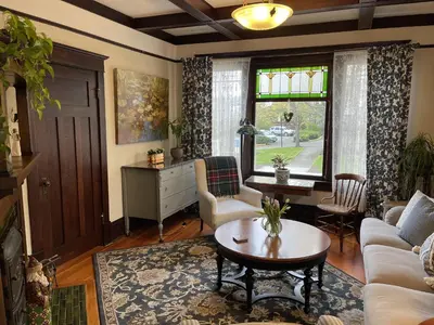 a living room with a couch and a table at Fisher House Victoria Bed and Breakfast in Victoria