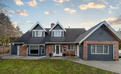 a brick house with a gray roof at Spacious & Modern by the Beach in White Rock