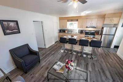 a living room with a couch and a table with flowers at Downie Cottage by Revelstoke Vacations in Revelstoke