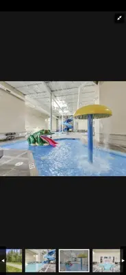 a pool with a yellow and red object in a building at Canmore Mountain Retreat. Hot Tub, Pool, King Bed! in Canmore