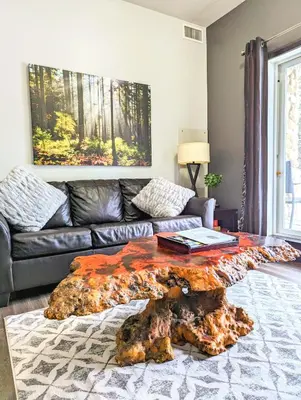 a living room with a couch and a coffee table at Canmore Mountain Retreat. Hot Tub, Pool, King Bed! in Canmore