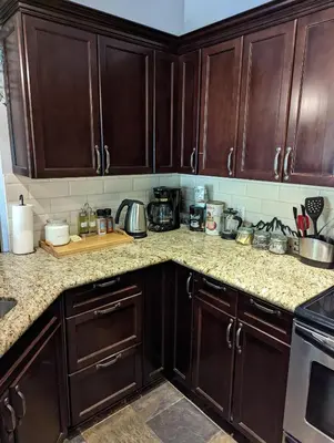 a kitchen with wooden cabinets and a counter top at Canmore Mountain Retreat. Hot Tub, Pool, King Bed! in Canmore