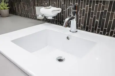 a white sink in a bathroom with a toilet at 2BR in Greyhawk, Hot Tub and Sauna, Gas Fireplace, Secure Parking in Whistler